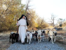 A sister of the Norbertine Canonesses of Bethlehem Priory of St. Joseph walks with some of the priory’s dogs, who are raised as part of their dog-breeding program in 2025.