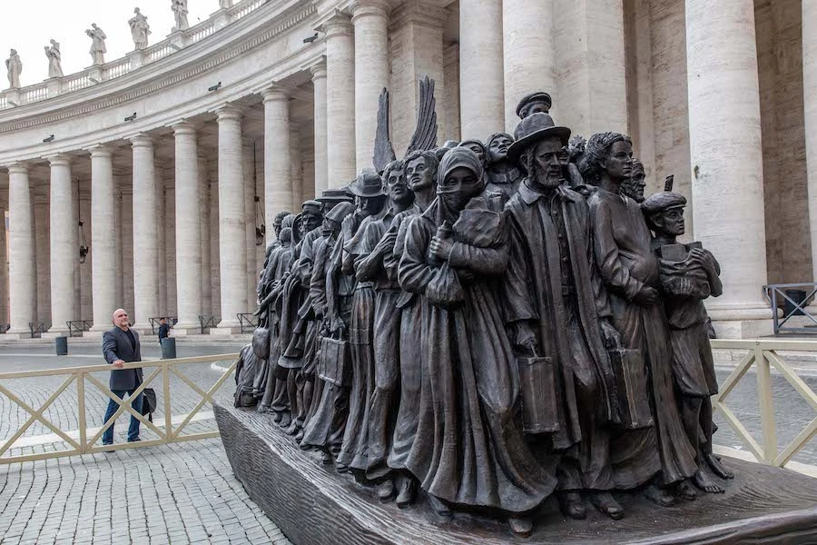 Canadian sculptor Timothy P. Schmalz poses next to his sculpture on the theme of refugees and migration, “Angels Unawares,” in St. Peter’s Square at the Vatican.?w=200&h=150
