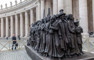 Canadian sculptor Timothy P. Schmalz poses next to his sculpture on the theme of refugees and migration, “Angels Unawares,” in St. Peter’s Square at the Vatican. Credit: Daniel Ibanez/CNA