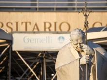 A statue of St. John Paul II is seen in front of the entrance to Rome's Gemelli hospital on Feb. 22, 2025, where Pope Francis continues to receive treatment for respiratory issues.