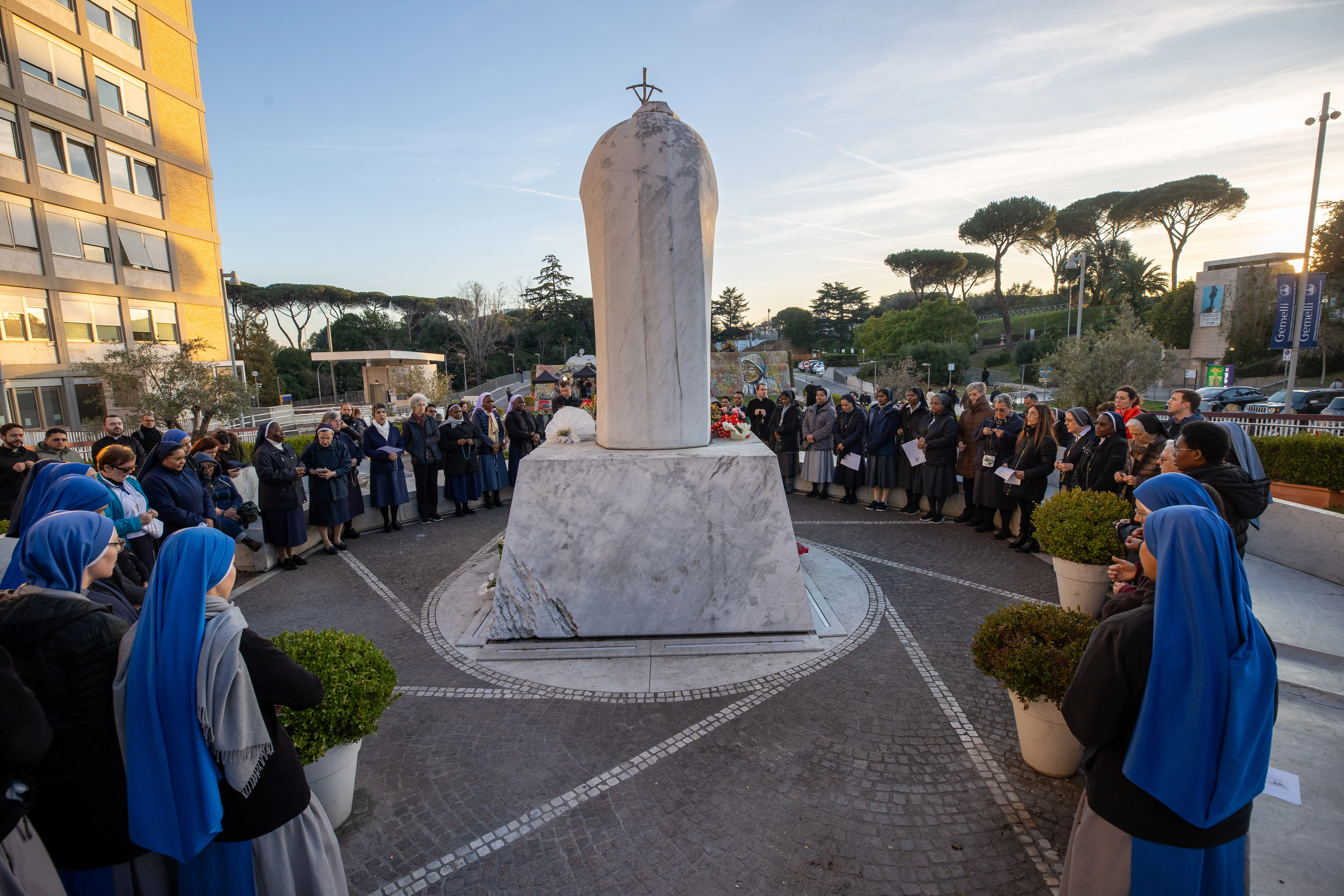 Religious sisters and dozens of faithful gather around the statue of St. John Paul II at Gemelli Hospital in Rome to pray the rosary for Pope Francis on Saturday afternoon, Feb. 22, 2025. Credit: Daniel Ibáñez/CNA