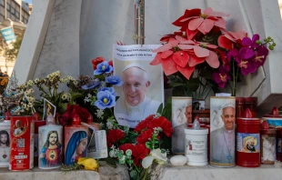 A makeshift shrine with devotional candles, flowers, and images of Pope Francis appears outside Rome’s Gemelli Hospital on Feb. 22, 2025. Credit: Daniel Ibáñez/CNA