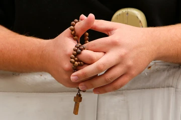 A pilgrim prays the Rosary in St Peters Square before the Wednesday general audience with Pope Francis on Oct 29 2014 Credit Daniel Ibez CNA CNA 10 29 14
