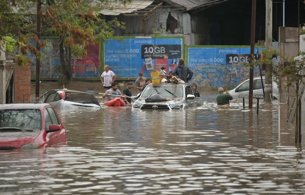 People gather on a flooded street after a powerful storm struck the city of Bahia Blanca, 373 miles south of Argentina’s capital, on March 7, 2025.?w=200&h=150