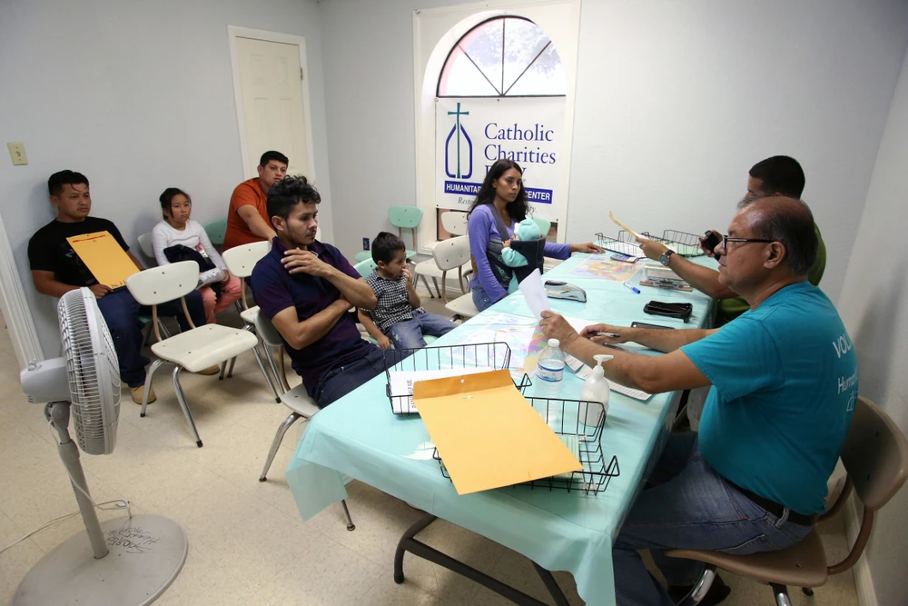 Volunteers at a Catholic Charities Humanitarian Respite Center help Central American refugees prepare to take a bus to go stay with U.S. family on Aug. 17, 2017, in McAllen, Texas.?w=200&h=150