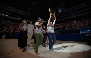 Perpetual Pilgrims from the St. Juan Diego Route process into Lucas Oil Stadium in July 2024 with an image of their patron saint. Credit: Jeffrey Bruno