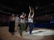 Perpetual Pilgrims from the St. Juan Diego Route process into Lucas Oil Stadium in July 2024 with an image of their patron saint.