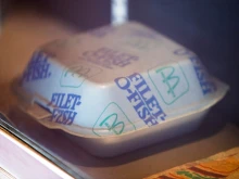 A vintage McDonald’s Filet-O-Fish container with blue and green branding.
