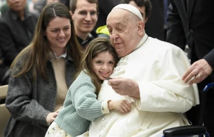 Pope Francis is hugged by a young visitor at his general audience at the Vatican, Wednesday, Feb. 12, 2025. Credit: Vatican Media
