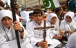 A Christian boy holds a crucifix during a protest in Karachi on Aug. 22, 2023, to condemn the attack on churches in Pakistan. More than 80 Christian homes and 19 churches were vandalized in an hourslong riot in Jaranwala in Punjab province on Aug. 16 after unverified reports that a Koran had been desecrated.