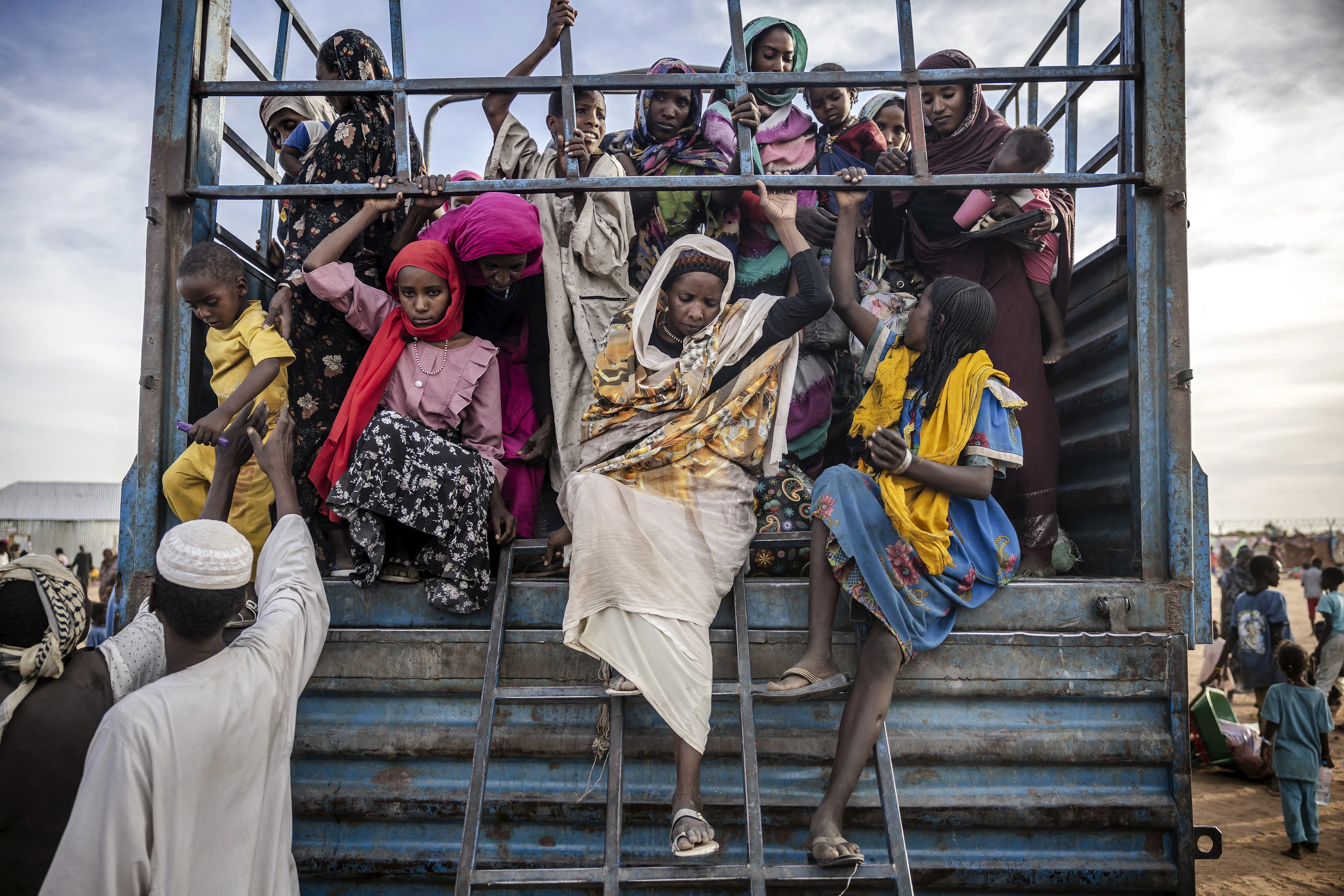Sudanese refugees who have fled from the war in Sudan get off a truck loaded with families arriving at a transit center for refugees on Feb. 13, 2024.?w=200&h=150
