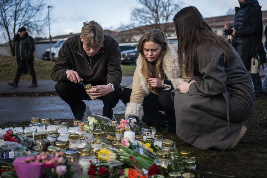 People light candles at a makeshift vigil near the adult education center Campus Risbergska school in Örebro, Sweden, on Feb. 5, 2025, one day after a shooting there left 11 people dead.?w=200&h=150