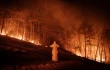 A wildfire blazes next to a stone lantern of family tomb in Andong, South Korea, on March 26, 2025. At least 18 people have been killed in one of South Korea’s worst wildfire outbreaks, with multiple blazes burning and causing “unprecedented damage,” the acting president said.
