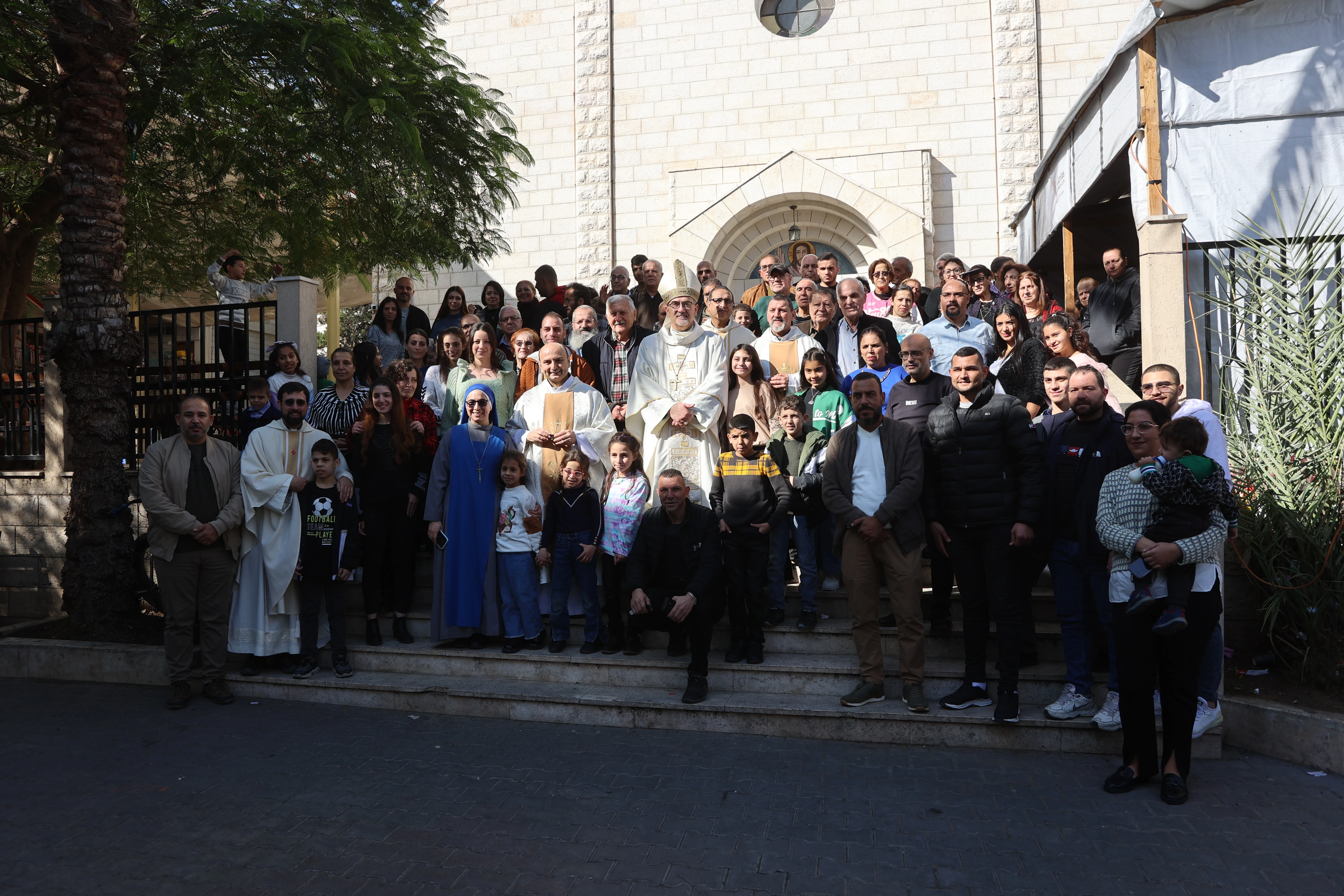 Group photo in front of the Church of the Sacred Family in Gaza during the visit of the Latin Patriarch of Jerusalem, Cardinal Pierbattista Pizzaballa, on Dec. 22, 2024.?w=200&h=150