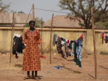 A Christian woman stands next to a clothesline while taking refuge in an internally displaced persons (IDP) camp at the Pilot Primary School after their houses were burnt as a result of religious strife in Mangu on Feb. 2, 2024, following weeks of intercommunal violence and unrest in the Plateau State.