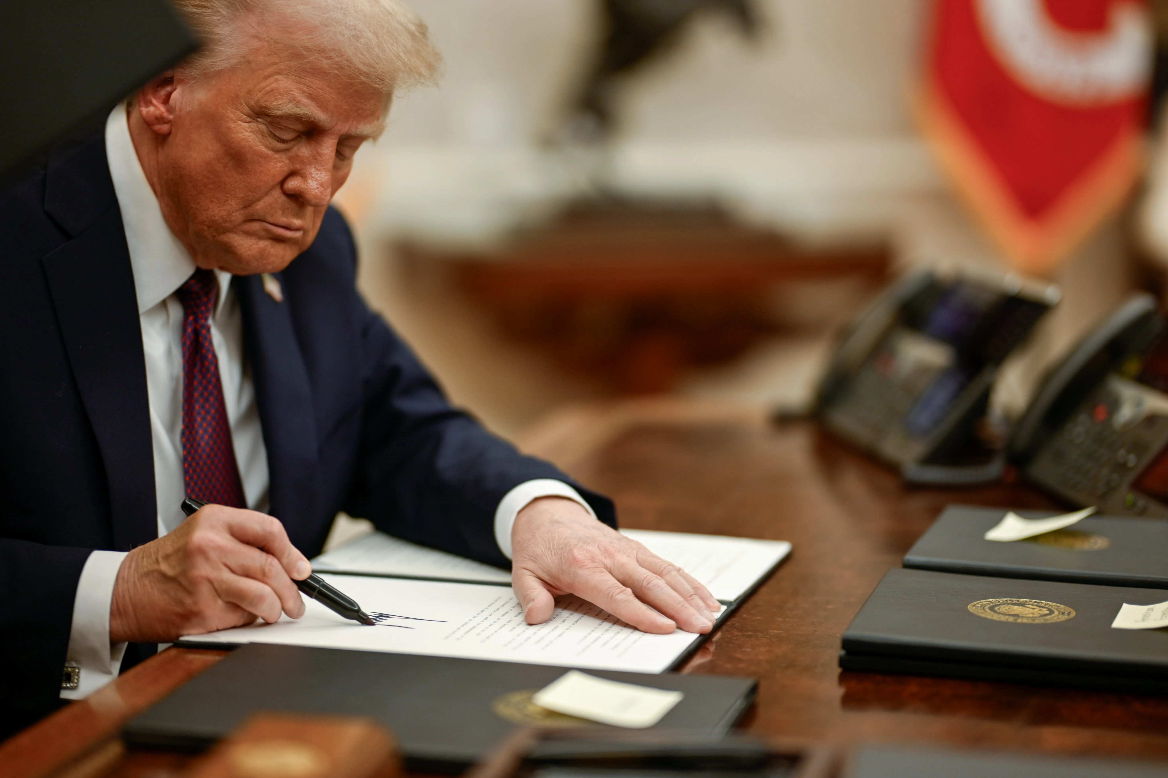 President Donald Trump signs executive orders in the Oval Office of the White House.?w=200&h=150