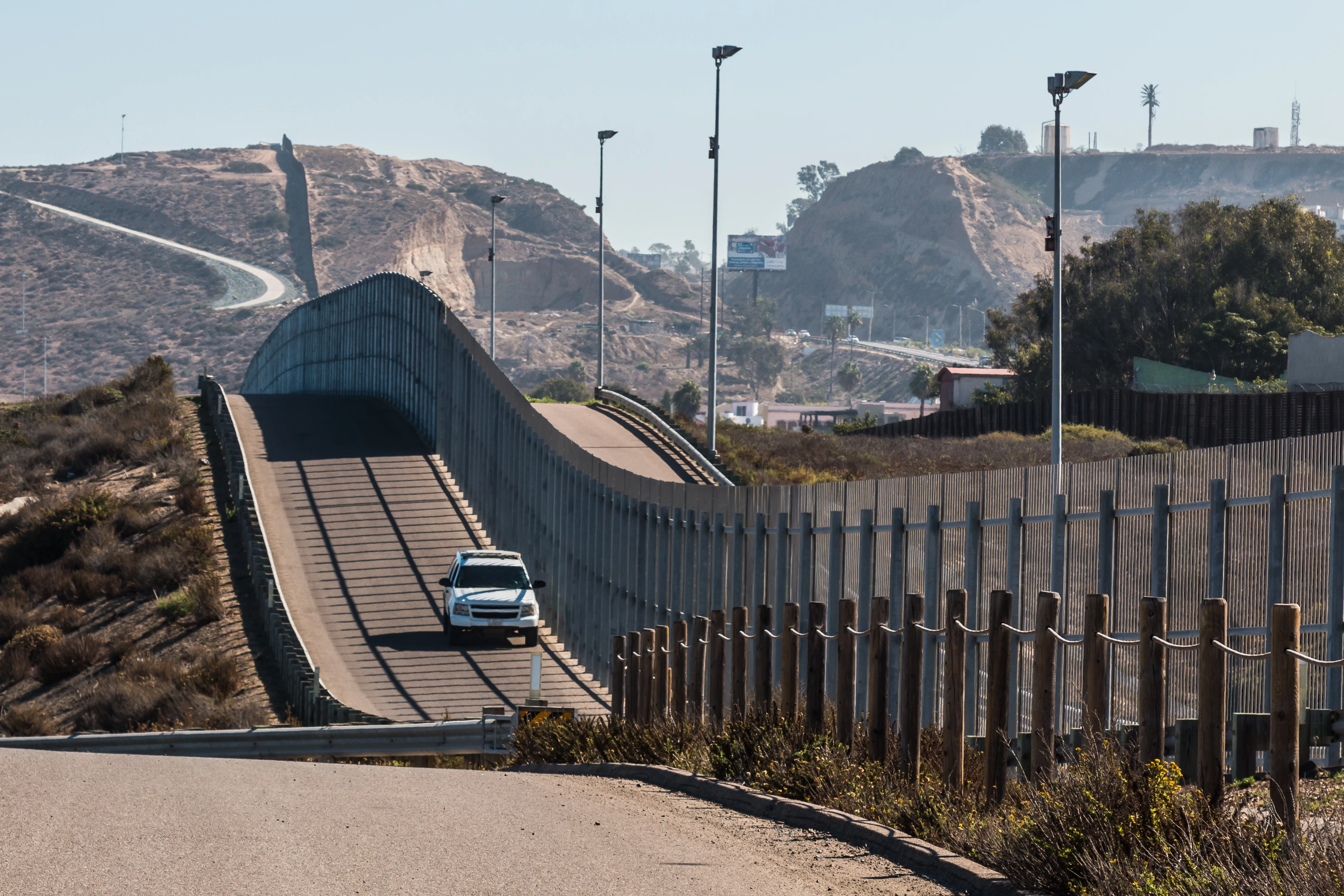 Border Patrol vehicle patrols the fence of the international border between San Diego and Tijuana, Mexico.?w=200&h=150