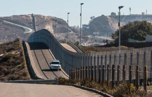 Border Patrol vehicle patrols the fence of the international border between San Diego and Tijuana, Mexico. Credit: Sherry V Smith/Shutterstock