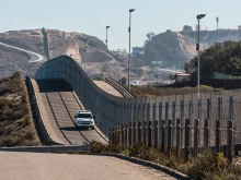 Border Patrol vehicle patrols the fence of the international border between San Diego and Tijuana, Mexico.