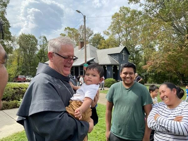 Bishop Michael Martin of Charlotte, North Carolina, greets a young Catholic while surveying storm damage at Swannanoa, North Carolina, Friday, on Oct. 4, 2024.?w=200&h=150