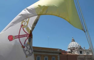 A Vatican flag waves over the dome of St. Peter’s Basilica. Credit: Bohumil Petrik/CNA