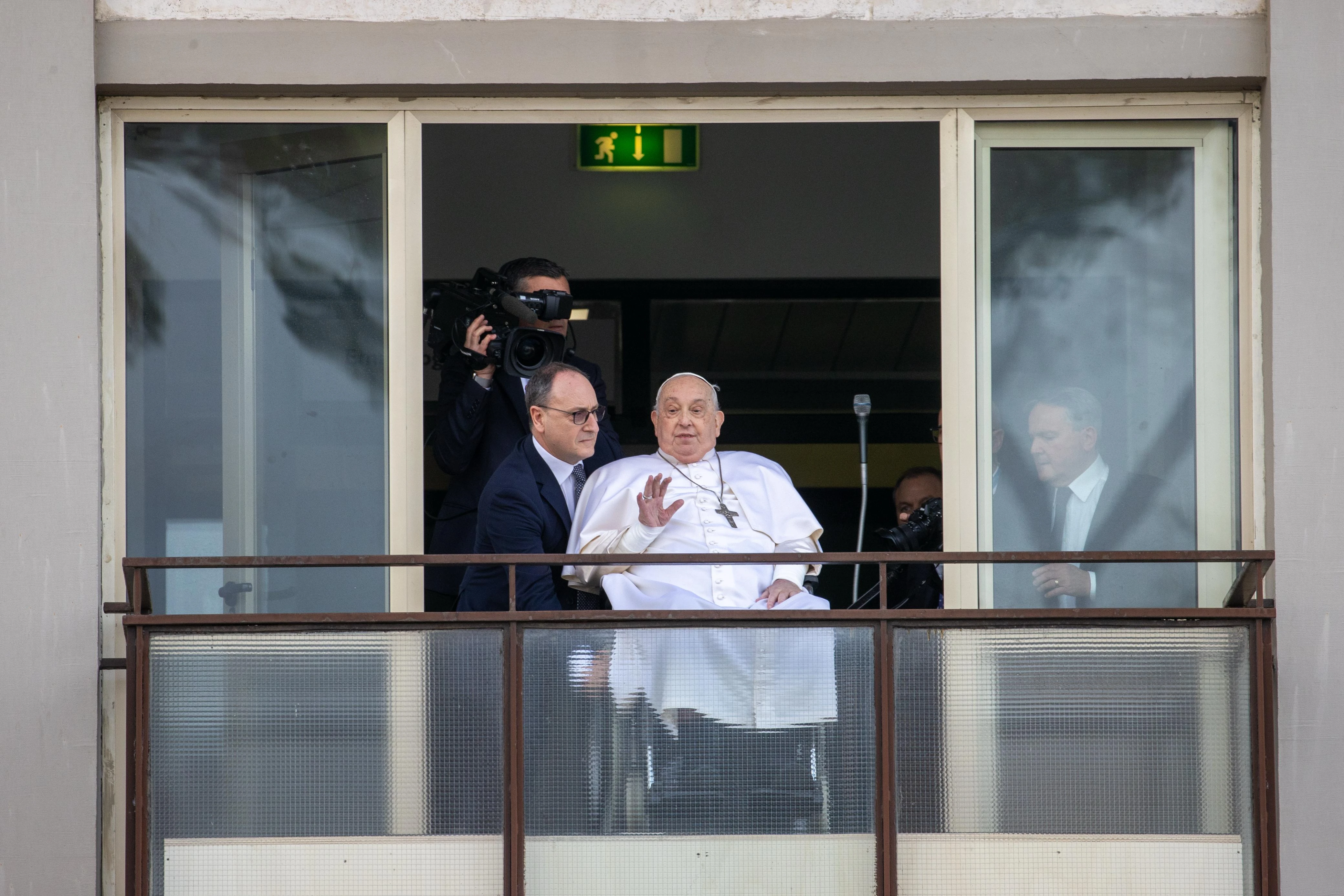 Pope Francis waves from a balcony at Gemelli Hospital in Rome on Sunday, March 23, 2025, following weeks of hospitalization for bilateral pneumonia.?w=200&h=150