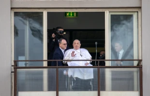 Pope Francis waves from a balcony at Gemelli Hospital in Rome on Sunday, March 23, 2025, following weeks of hospitalization for bilateral pneumonia. Credit: Daniel Ibáñez/CNA