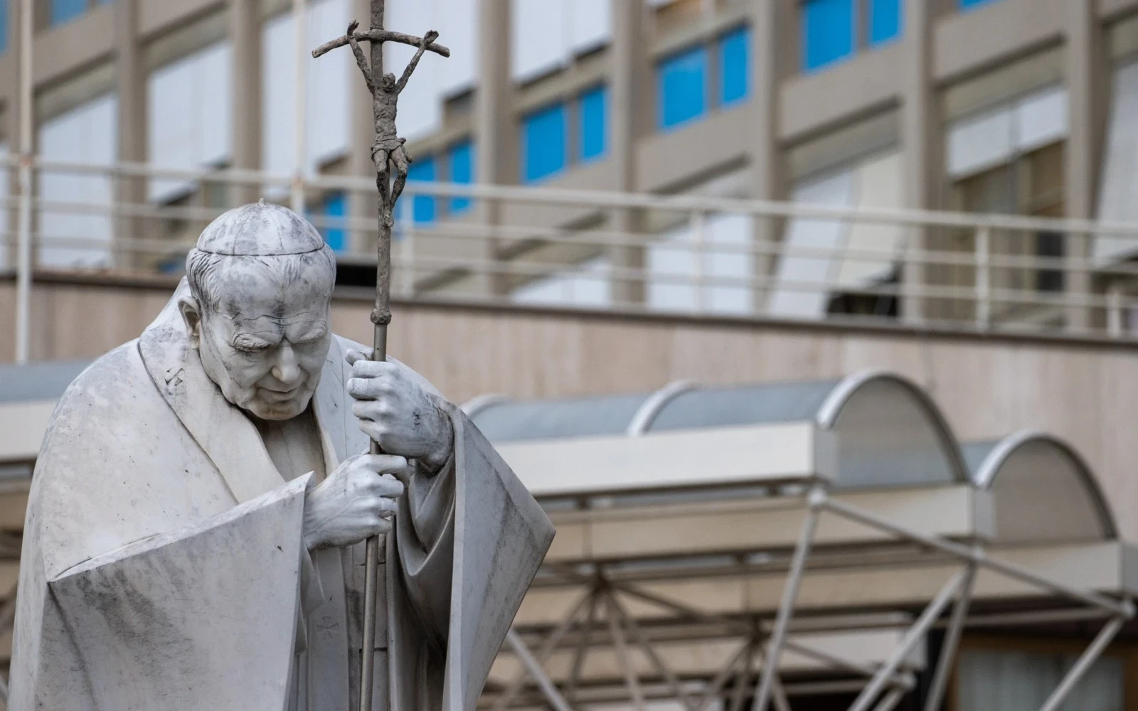 A statue of St. John Paul II holding a crucifix stands outside Rome’s Gemelli University Hospital. | Credit: Daniel Ibáñez/CNA