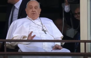 Pope Francis waves from a balcony at Gemelli Hospital in Rome on Sunday, March 23, 2025, following weeks of hospitalization for bilateral pneumonia. Credit: Vatican Media/Screenshot