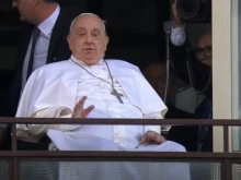 Pope Francis waves from a balcony at Gemelli Hospital in Rome on Sunday, March 23, 2025, following weeks of hospitalization for bilateral pneumonia.