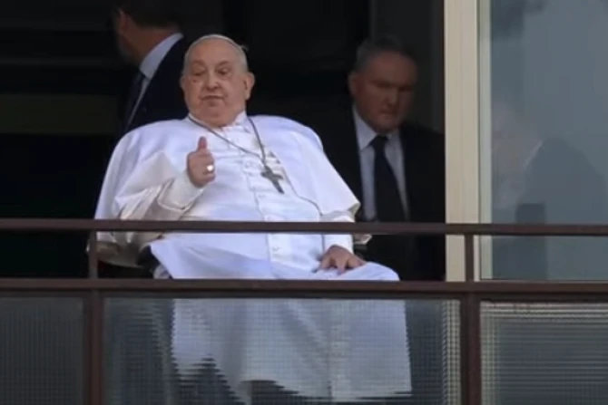 Pope Francis gives a thumbs up gesture from his window at Gemelli Hospital in Rome during his first public appearance in weeks on Sunday, March 23, 2025.