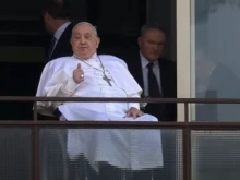 Pope Francis gives a thumbsup gesture from his window at Gemelli Hospital in Rome during his first public appearance in weeks on Sunday, March 23, 2025.