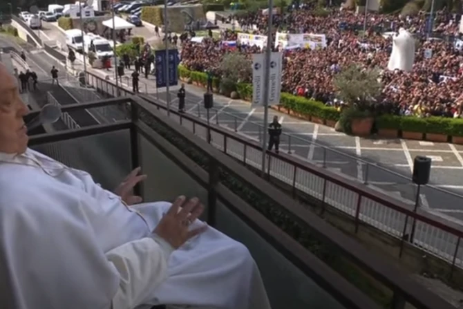 Pope Francis waves to the gathered faithful from the balcony at Gemelli Hospital in Rome on Sunday, March 23, 2025
